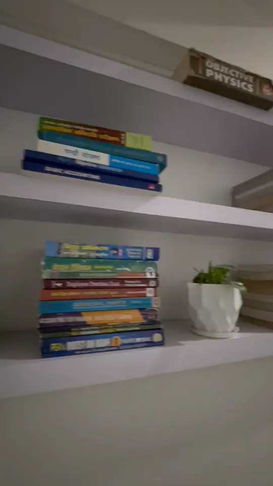 Video of wall shelves stacked with exam prep books.