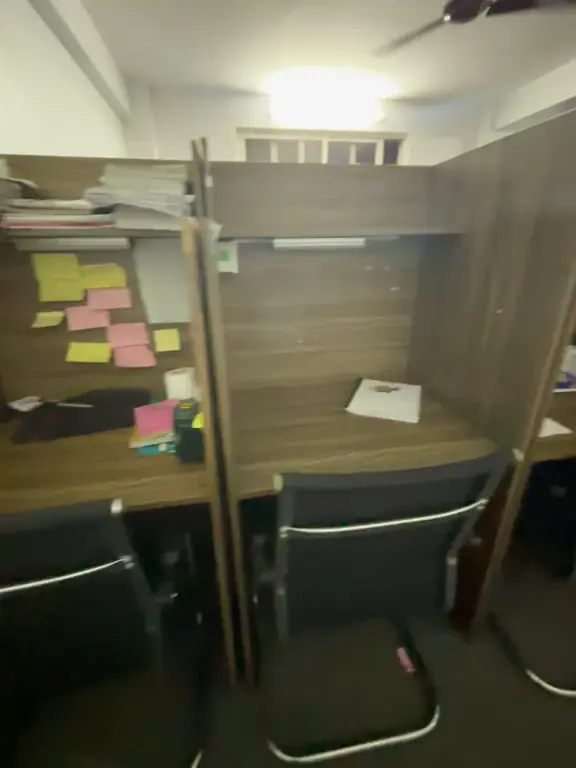 Video of a cabin desk with notes pinned up and books on the shelf.