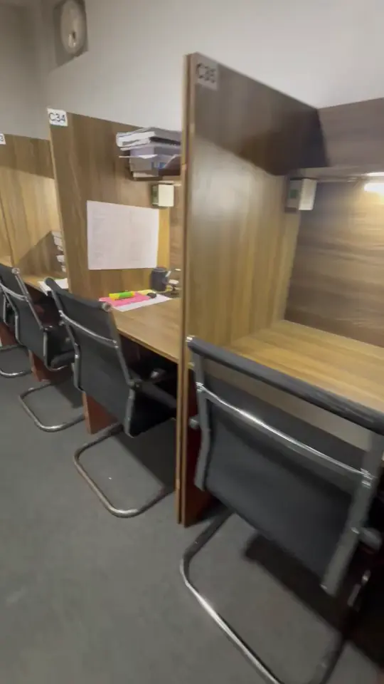 Video of a row of cabins with books stacked on the desks.