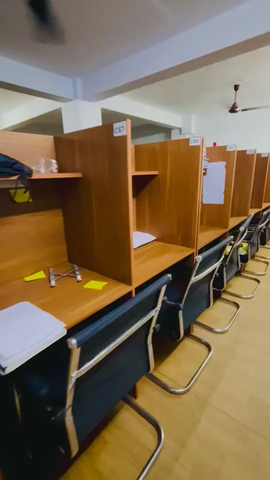 Video of wooden cabins in a bright hall.