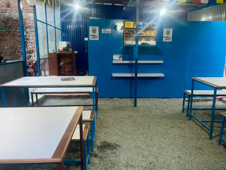 Video of the covered outdoor break area with tables and benches.
